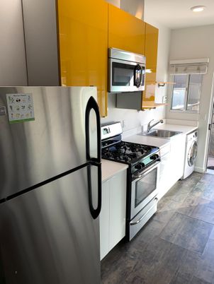 Interior, Kitchen, Recessed Lighting, Washer, Wood Texture Flooring