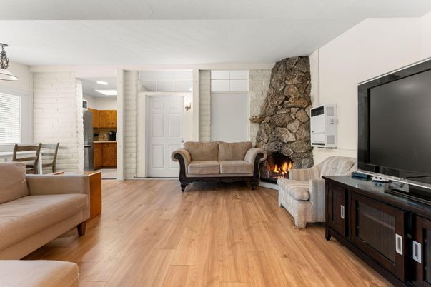 Dining room, Fireplace, Interior, Living room, Recessed Lighting, Stone Walls, Wood Texture Flooring