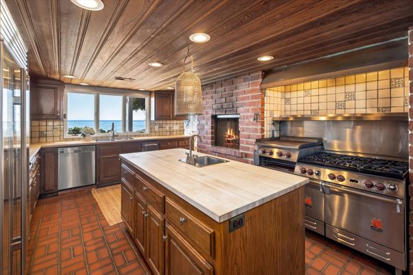 Fireplace, Interior, Kitchen, Pendant Lights, Recessed Lighting, Stainless Steel Appliances, Stone Walls, Water, Wooden Ceilings