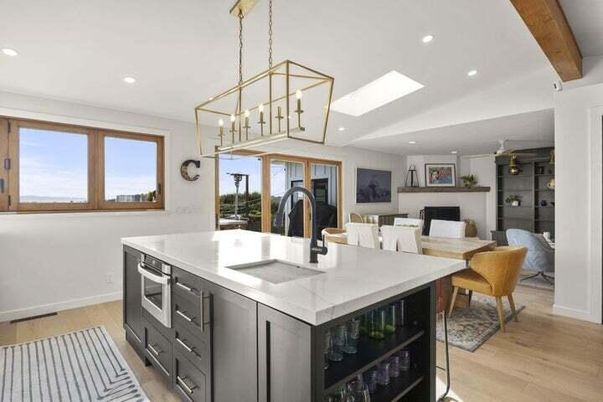 Chandelier, Dining room, Fireplace, Interior, Kitchen, Living room, Pendant Lights, Recessed Lighting, Stainless Steel Appliances, Wooden Beams, Wood Texture Flooring