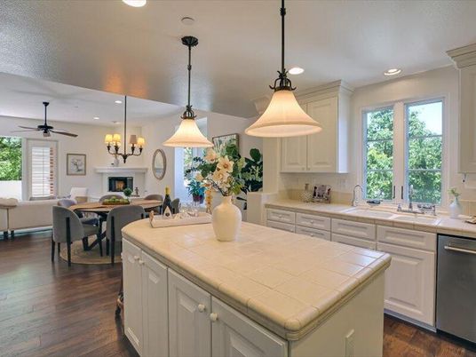 Dining room, Fireplace, Interior, Kitchen, Pendant Lights, Recessed Lighting, Stainless Steel Appliances, Tile Countertops, Wood Texture Flooring