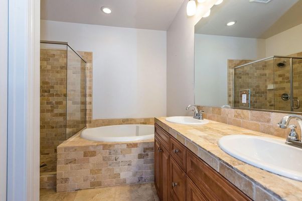 Bathroom, Dual Sink Vanities, Glass Shower, Interior, Recessed Lighting, Stone Walls, Tile Countertops