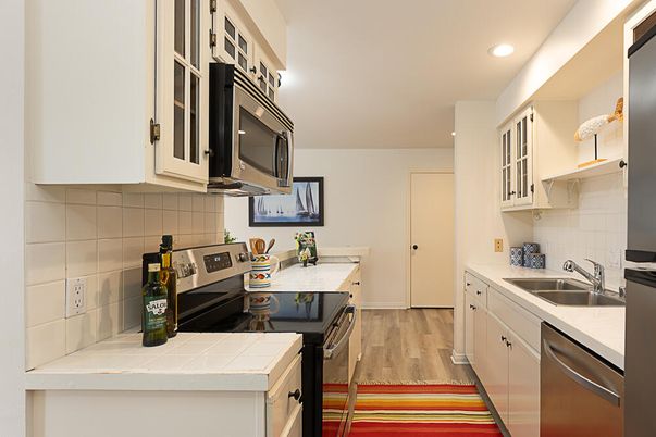 Interior, Kitchen, Recessed Lighting, Tile Countertops, Wood Texture Flooring