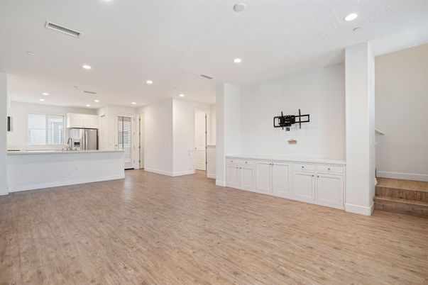 Empty room, Interior, Kitchen, Recessed Lighting, Stainless Steel Appliances, Wood Texture Flooring