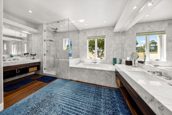 Bathroom, Dual Sink Vanities, Glass Shower, Interior, Marble Walls, Recessed Lighting, Wood Texture Flooring