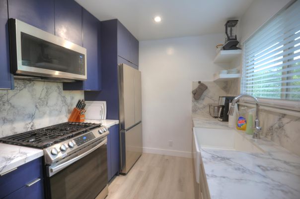 Interior, Kitchen, Marble Walls, Recessed Lighting, Stainless Steel Appliances, Wood Texture Flooring