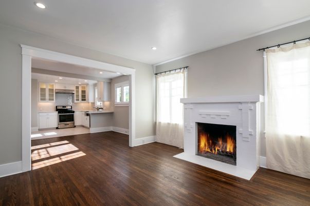 Empty room, Fireplace, Interior, Kitchen, Recessed Lighting, Stainless Steel Appliances, Wood Texture Flooring