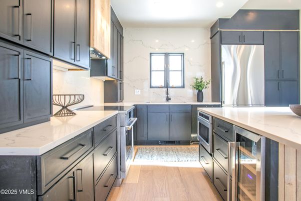 Interior, Kitchen, Marble Walls, Recessed Lighting, Stainless Steel Appliances, Wood Texture Flooring