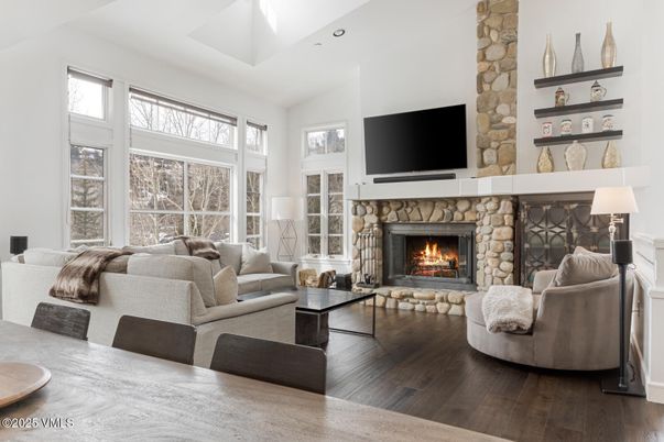 Dining room, Fireplace, Interior, Living room, Recessed Lighting, Stone Walls, Wood Texture Flooring