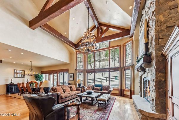 Chandelier, Dining room, Fireplace, Interior, Living room, Recessed Lighting, Stone Walls, Wooden Beams, Wood Texture Flooring