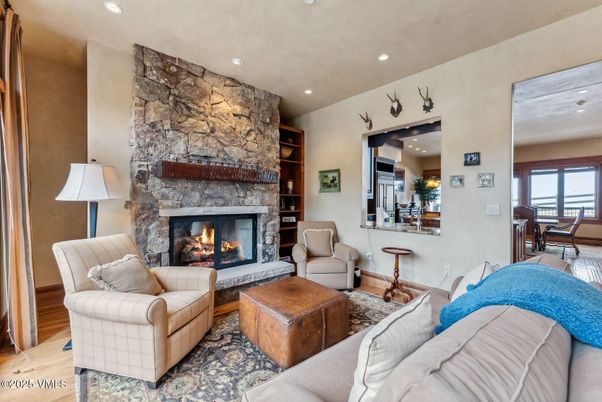 Dining room, Fireplace, Interior, Living room, Recessed Lighting, Stone Walls, Wood Texture Flooring