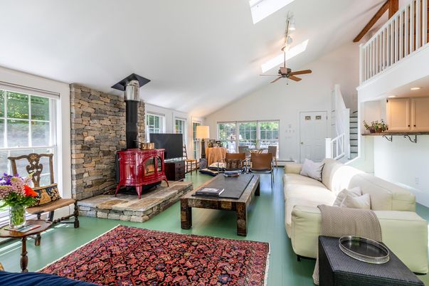 Dining room, Fireplace, Interior, Living room, Recessed Lighting, Stone Walls, Wood Texture Flooring