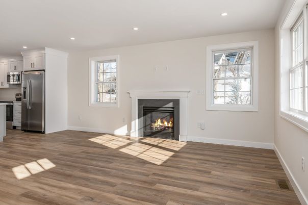 Empty room, Fireplace, Interior, Kitchen, Recessed Lighting, Stainless Steel Appliances, Wood Texture Flooring
