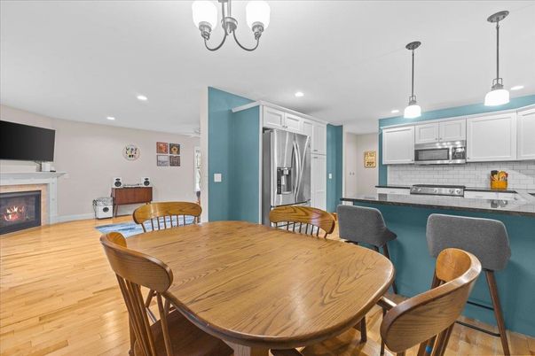Dining room, Fireplace, Interior, Kitchen, Pendant Lights, Recessed Lighting, Stainless Steel Appliances, Wood Texture Flooring
