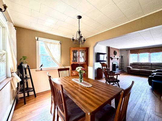 Chandelier, Dining room, Fireplace, Interior, Living room, Stone Walls, Wood Texture Flooring