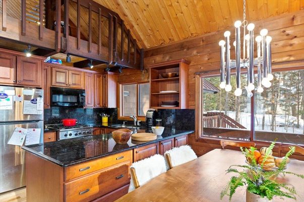 Chandelier, Dining room, Interior, Kitchen, Pendant Lights, Stainless Steel Appliances, Wooden Ceilings, Wood Texture Flooring, Wooden Walls