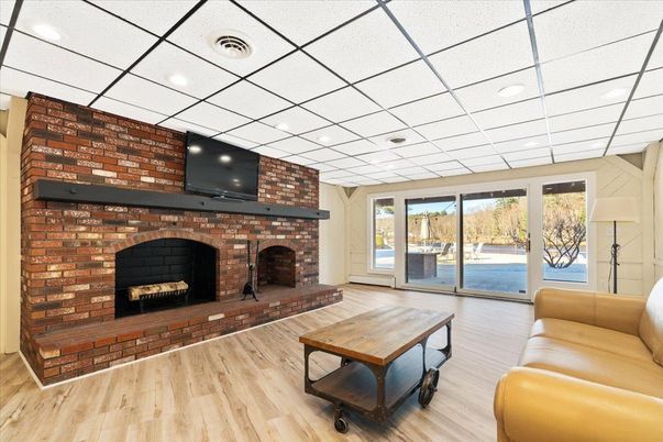 Fireplace, Interior, Living room, Recessed Lighting, Stone Walls, Wood Texture Flooring