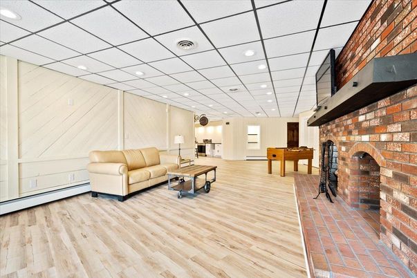 Fireplace, Interior, Living room, Recessed Lighting, Stone Walls, Wood Texture Flooring