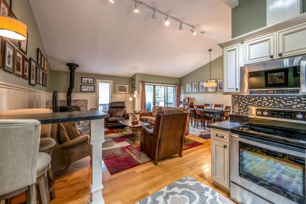 Dining room, Fireplace, Interior, Kitchen, Living room, Pendant Lights, Stone Walls, Wood Texture Flooring