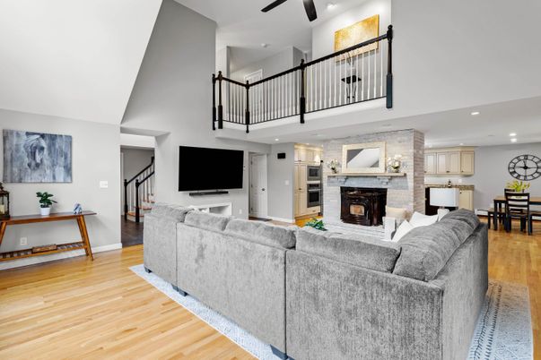 Dining room, Fireplace, Interior, Living room, Recessed Lighting, Stone Walls, Wood Texture Flooring