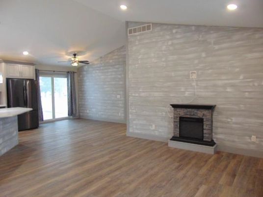 Empty room, Fireplace, Interior, Kitchen, Recessed Lighting, Stone Walls, Wood Texture Flooring