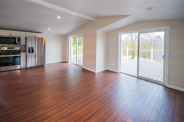 Empty room, Interior, Kitchen, Recessed Lighting, Stainless Steel Appliances, Wood Texture Flooring