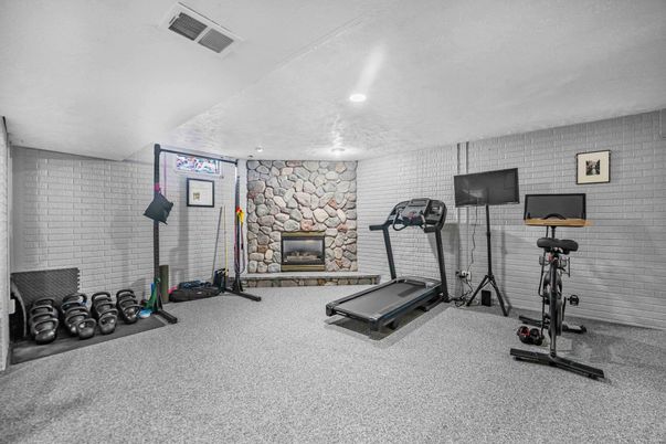 Fireplace, Fitness Equipment, Interior, Recessed Lighting, Stone Walls