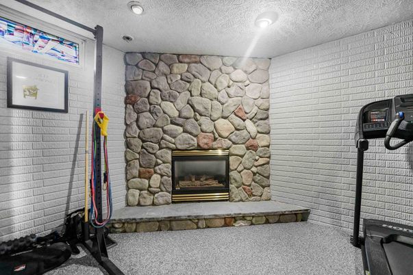 Fireplace, Fitness Equipment, Interior, Recessed Lighting, Stone Walls
