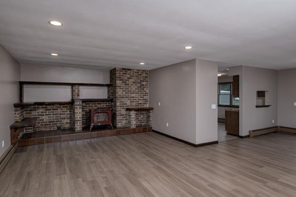 Empty room, Fireplace, Interior, Recessed Lighting, Stone Walls, Wood Texture Flooring