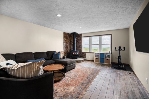 Fireplace, Interior, Living room, Recessed Lighting, Stone Walls, Wood Texture Flooring