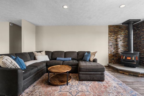 Fireplace, Interior, Living room, Recessed Lighting, Stone Walls, Wood Texture Flooring