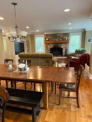 Chandelier, Dining room, Fireplace, Interior, Living room, Recessed Lighting, Stone Walls, Wood Texture Flooring