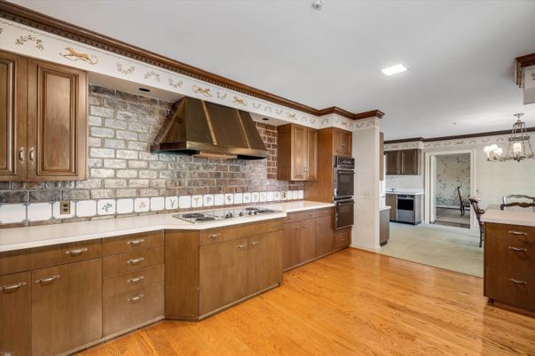 Chandelier, Dining room, Interior, Kitchen, Recessed Lighting, Stainless Steel Appliances, Wood Texture Flooring