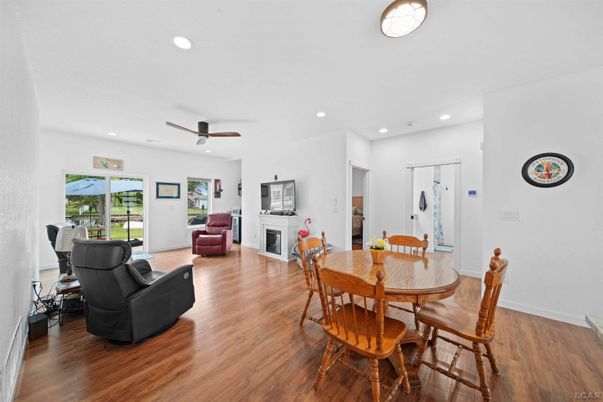 Dining room, Fireplace, Interior, Living room, Recessed Lighting, Wood Texture Flooring