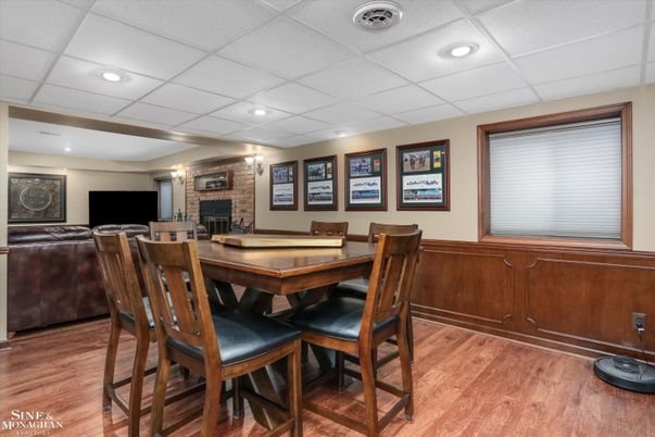 Dining room, Fireplace, Interior, Recessed Lighting, Stone Walls, Wood Texture Flooring
