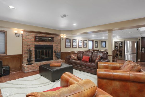Fireplace, Interior, Living room, Recessed Lighting, Stainless Steel Appliances, Stone Walls, Wood Texture Flooring