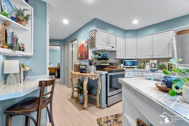 Interior, Kitchen, Recessed Lighting, Stainless Steel Appliances, Tile Countertops, Wood Texture Flooring