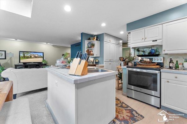 Interior, Kitchen, Recessed Lighting, Stainless Steel Appliances, Tile Countertops, Wood Texture Flooring