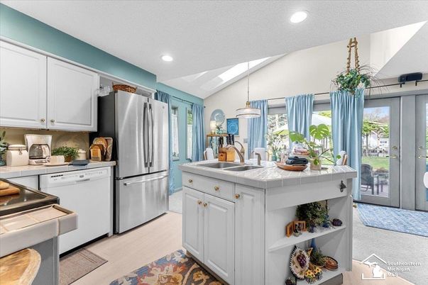 Interior, Kitchen, Pendant Lights, Recessed Lighting, Stainless Steel Appliances, Tile Countertops, Wood Texture Flooring