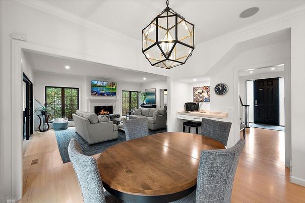 Chandelier, Dining room, Fireplace, Interior, Living room, Pendant Lights, Recessed Lighting, Wood Texture Flooring