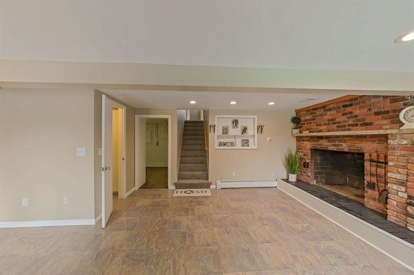 Empty room, Fireplace, Interior, Recessed Lighting, Stone Walls, Wood Texture Flooring