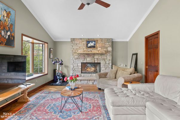 Fireplace, Fitness Equipment, Interior, Living room, Recessed Lighting, Stone Walls, Wood Texture Flooring