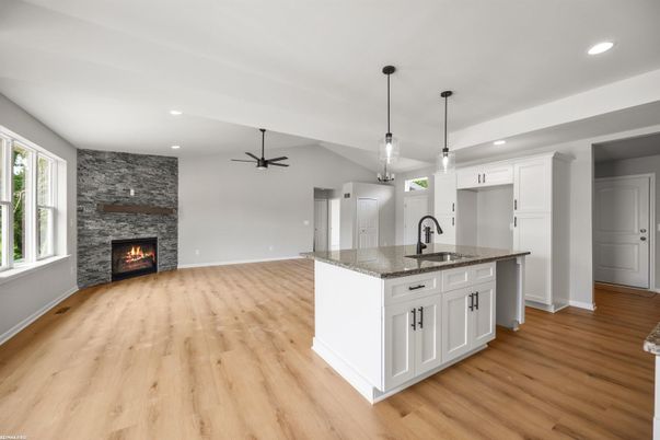Empty room, Fireplace, Interior, Kitchen, Pendant Lights, Recessed Lighting, Stone Walls, Wood Texture Flooring
