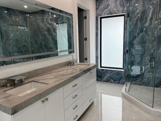 Bathroom, Dual Sink Vanities, Glass Shower, Interior, Marble Walls, Recessed Lighting