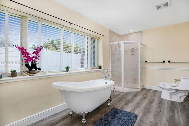 Bathroom, Free Standing Baths, Glass Shower, Interior, Recessed Lighting, Wood Texture Flooring