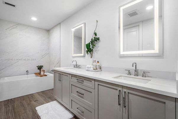 Bathroom, Dual Sink Vanities, Interior, Marble Walls, Recessed Lighting, Wood Texture Flooring