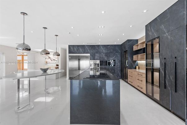 Interior, Kitchen, Marble Walls, Pendant Lights, Recessed Lighting, Stainless Steel Appliances