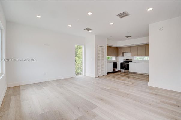 Empty room, Interior, Kitchen, Recessed Lighting, Stainless Steel Appliances, Wood Texture Flooring