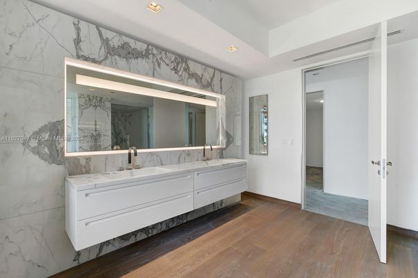 Bathroom, Dual Sink Vanities, Interior, Marble Walls, Recessed Lighting, Wood Texture Flooring