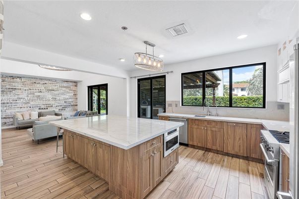 Interior, Kitchen, Living room, Pendant Lights, Recessed Lighting, Stainless Steel Appliances, Stone Walls, Wood Texture Flooring